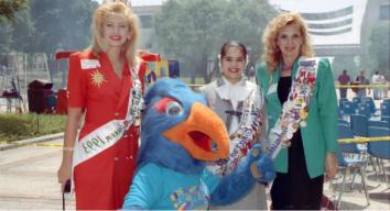 Two women wearing sashes with Rowdy