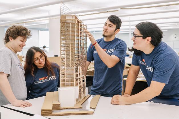 Architecture students working on a building model